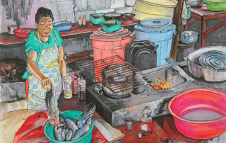 Woman frying fish in Suan, Colombia.